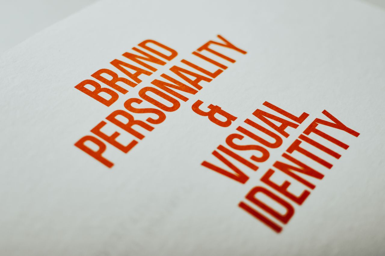 services-01 Close-up of Brand Personality & Visual Identity text in red on white paper.