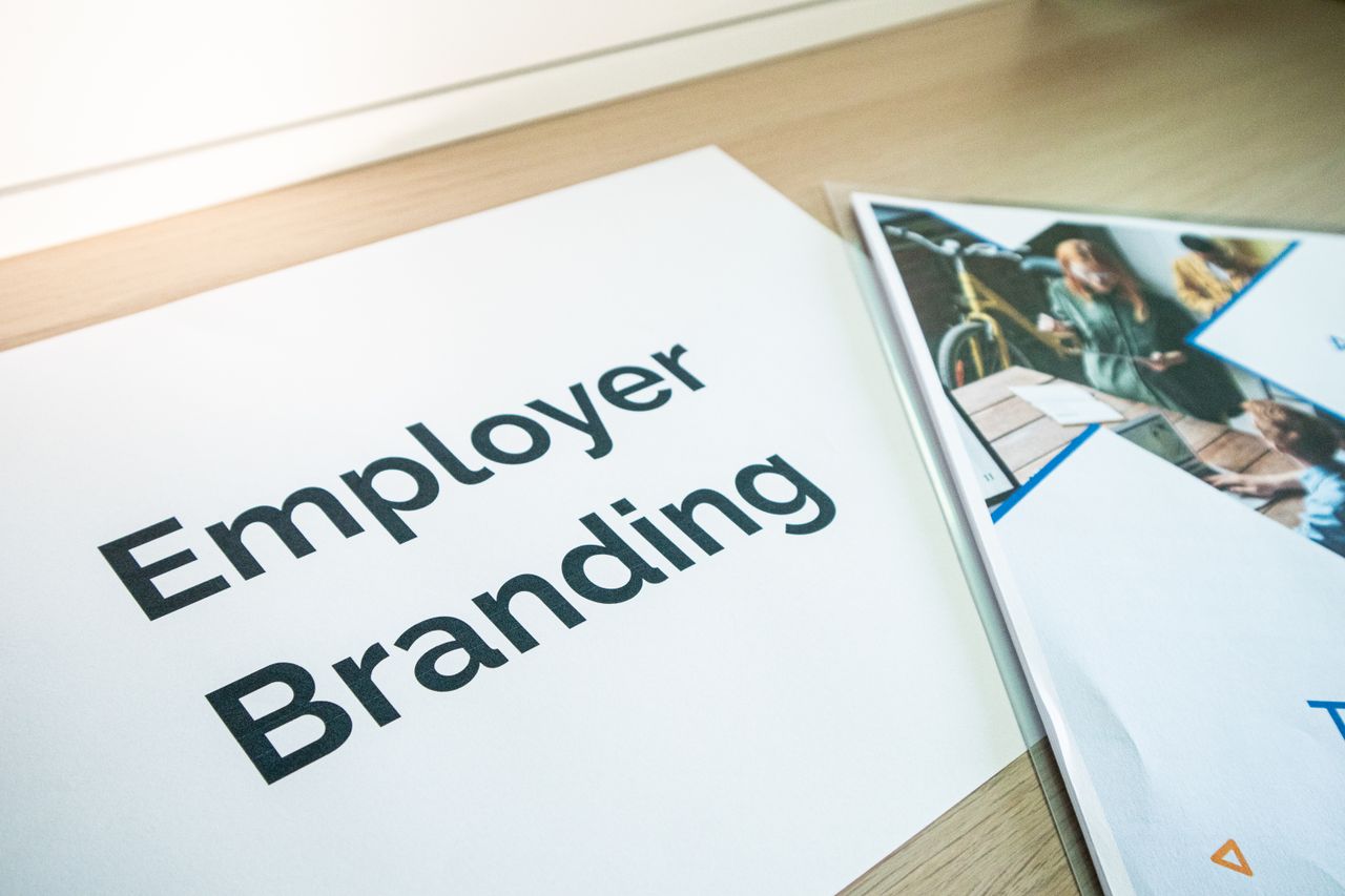 about-us-02 Focus on employer branding with documents on a wooden desk, ideal for business concepts.